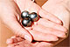 Three Tahitian Pearls on a woman's palms